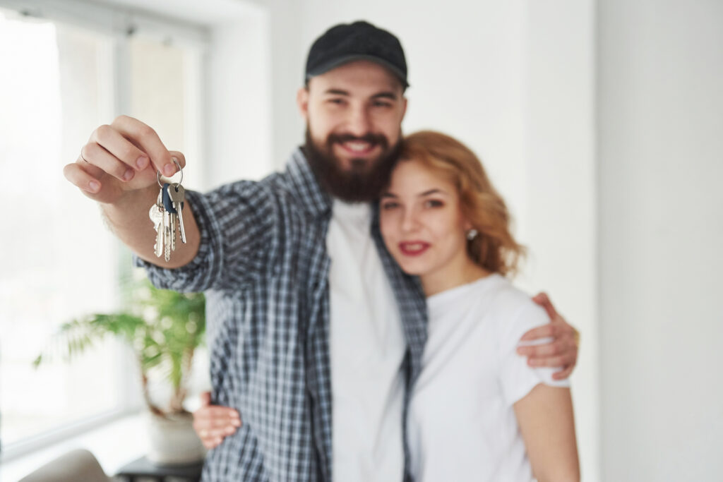 Happy couple together in their new house. Conception of moving
